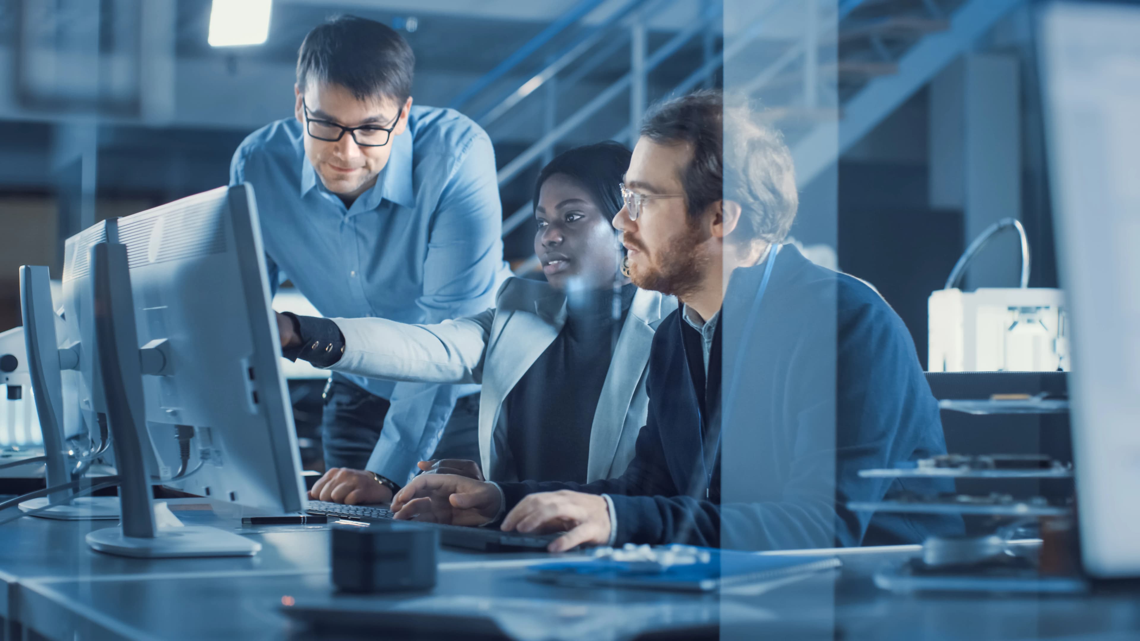 A DigiDaaS engineering team collaborating at their workstations